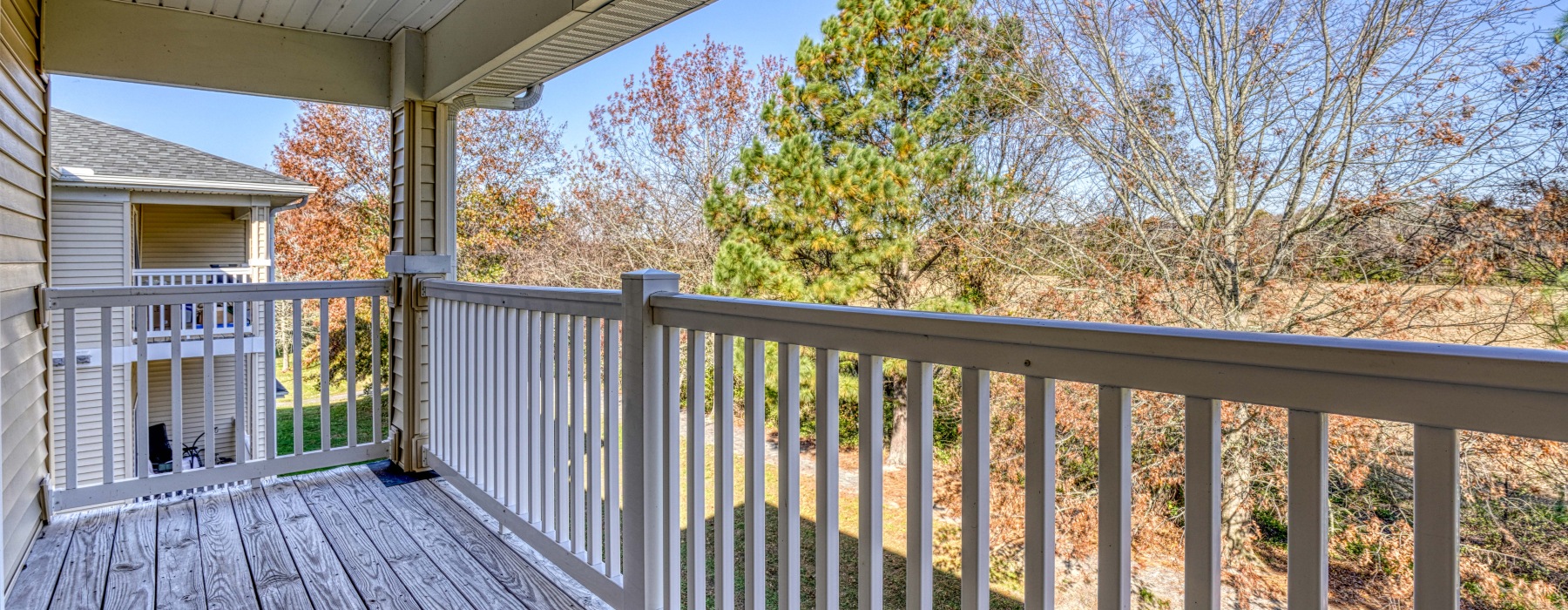 Covered private apartment balcony overlooking wooded views at Mill Pond Village in Salisbury, Maryland